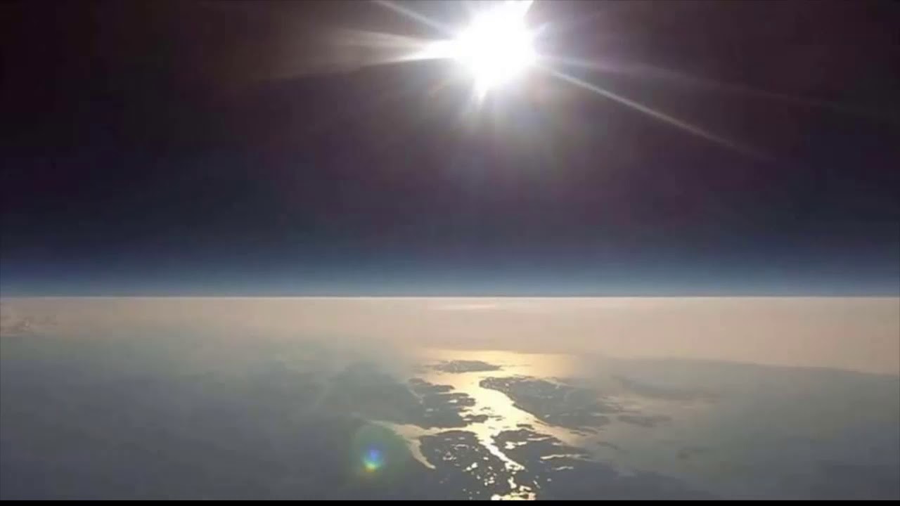 Balloon footage showing a localized bright hot-spot of sunlight reflecting on the cloud layer below, the behaviour of a near light source.