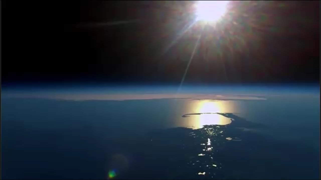 Balloon footage showing a localized reflection of the sun on the cloud layer.