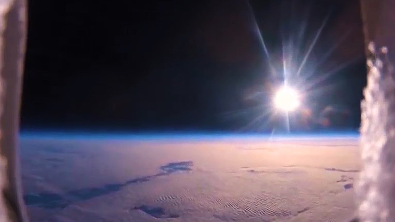 Balloon footage showing a spotlight of sunlight over a cloud sheet from high altitude.