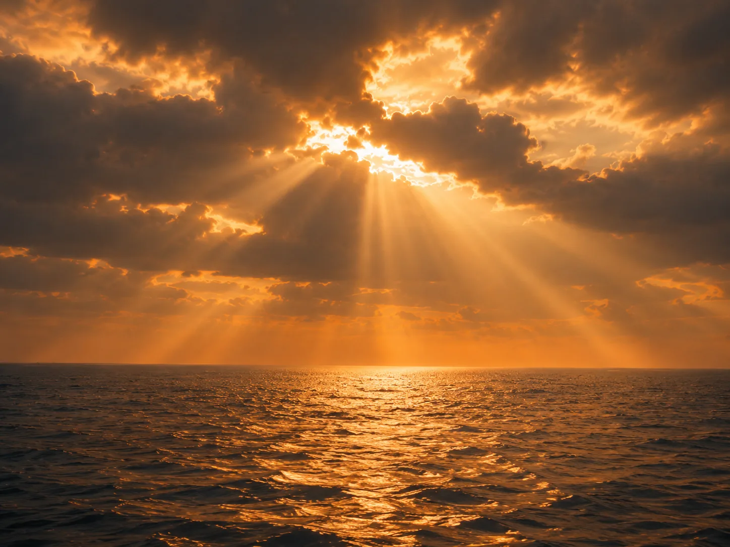 Crepuscular rays breaking through cloud and visibly converging at a point not far above the cloud layer, the behaviour of a near, local light source.